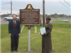 Carolyn Brown standing with the historical marker