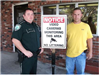 brusly Police Officer Tom Southon and brusly Police Chief Jamie Whaley next to No Littering sign