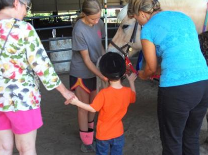 Child petting a horse